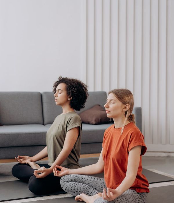 Woman practicing a calm yoga pose in a minimalist setting.